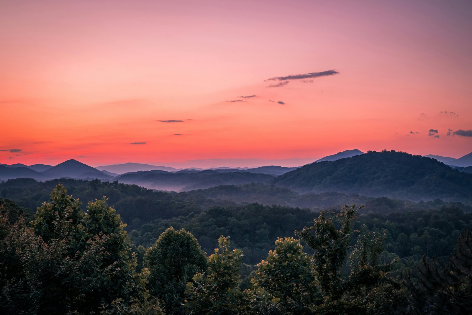 A breathtaking view of mountains under a vivid sunset sky, showcasing natural beauty and tranquility.